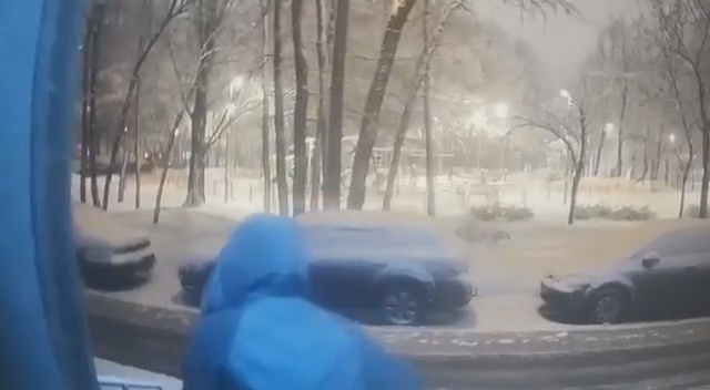 На этом видео женщина выходит из подъезда: видны другие автомобили, нет строения во дворе справа, а то, что впереди, похоже на детскую площадку