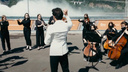 Согласования заняли две недели: оркестр филармонии сыграл на фоне водосброса Красноярской ГЭС