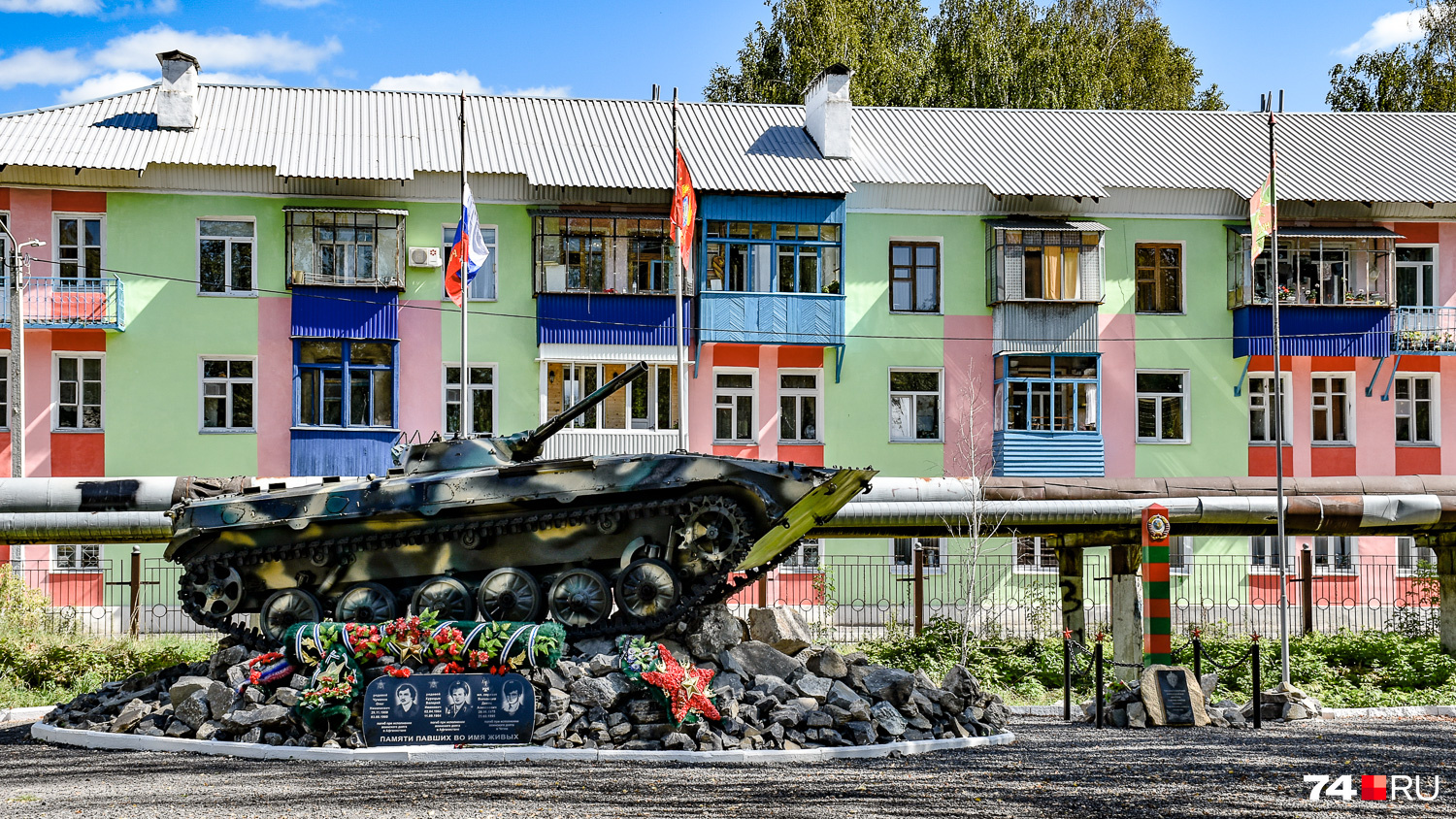 Памятник бойцам ВДВ на фоне расцвеченного дома в центральном парке