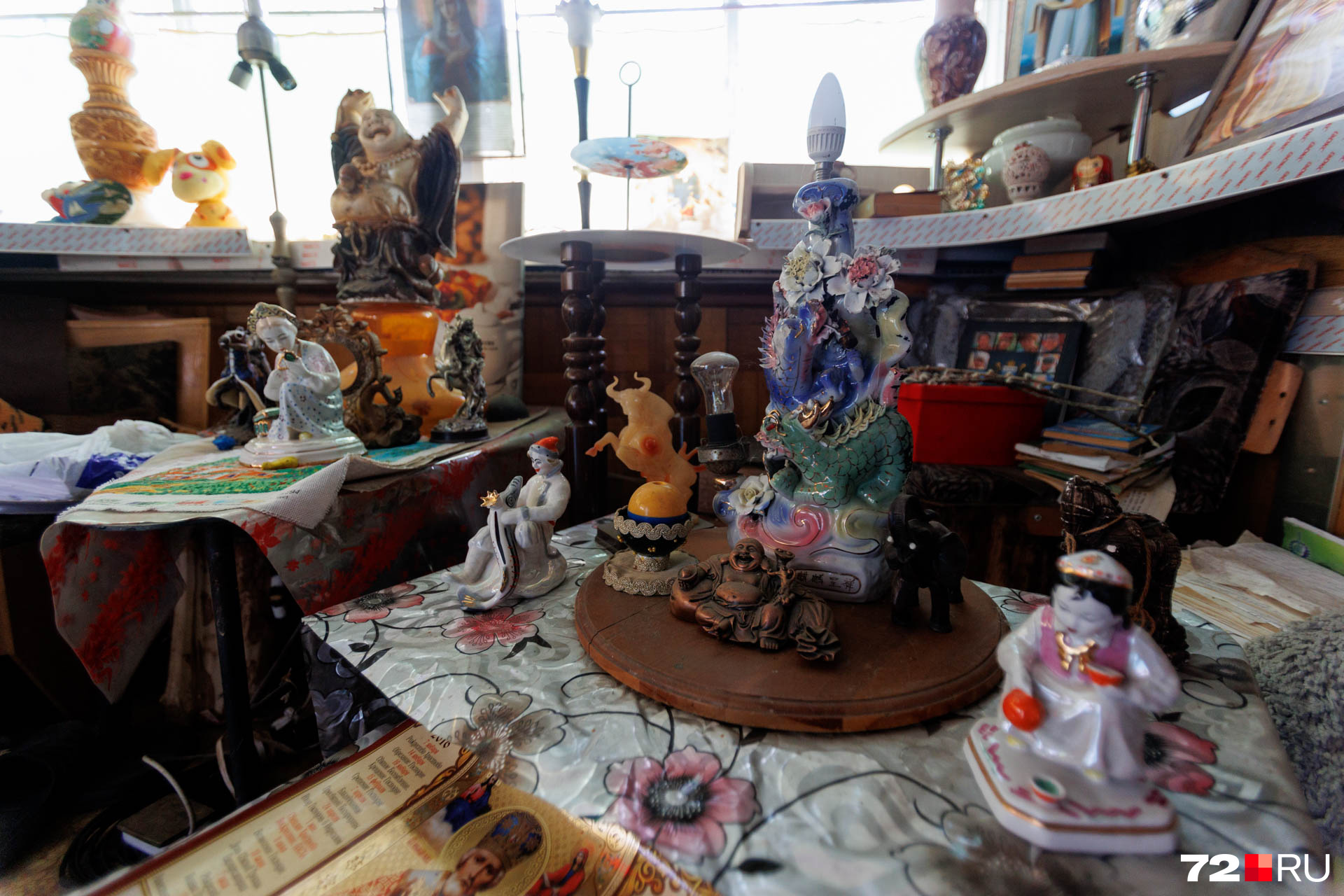 Сказочные персонажи, статуя Будды и иконы в одном месте