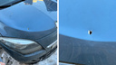 Кусок кирпича с облицовки здания пробил капот припаркованной у дома машины в Новосибирске