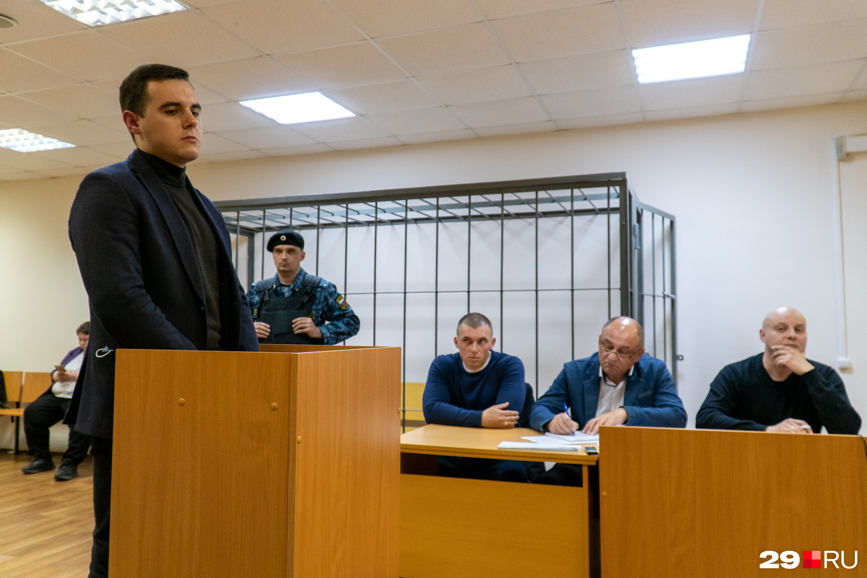 Справа по разные стороны от адвоката сидят уволенные из ГИБДД Александр Овсянников и Дмитрий Гришин — слушают, как отвечает потерпевший водитель